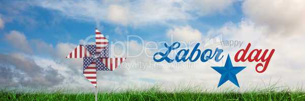 Happy labor day text and USA wind catcher in front of grass and sky