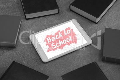 Tablet on a school table with back to school text on screen