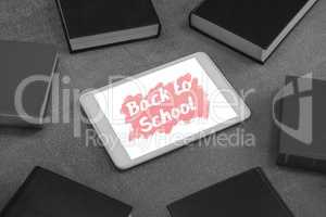 Tablet on a school table with back to school text on screen