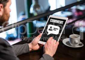Comment text and chat graphic on tablet screen with mans hands