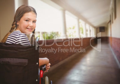 Disabled girl in wheelchair in school corridor