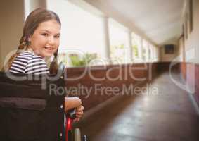 Disabled girl in wheelchair in school corridor