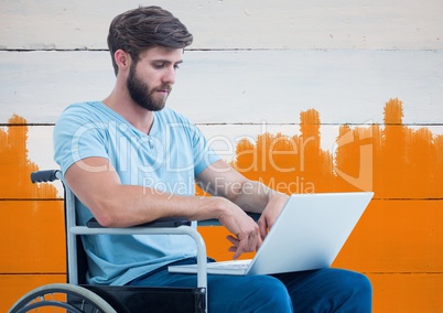 Disabled man in wheelchair with bright painted orange background