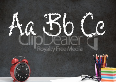 Desk foreground with blackboard graphics of ABC spelling