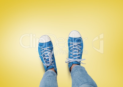 Blue shoes on feet with yellow background