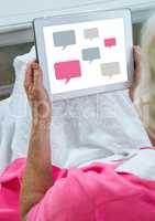 Chat icons on tablet in womans hand