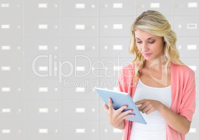 female student holding tablet in front of lockers