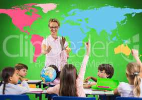 Kids in class in front of colorful world map with teacher