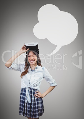 Happy woman holding a VR headset with speech bubble against grey background