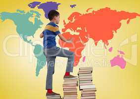 Schoolboy climbing tower of books in front of colorful world map