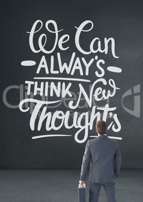 Business man standing in front of a motivational text