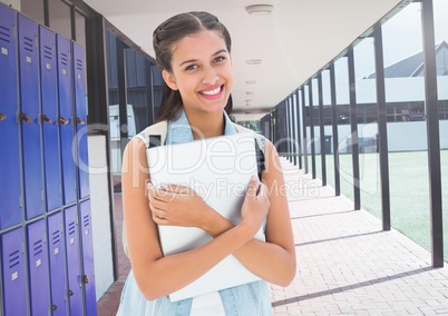 female student holding file in front of lockers