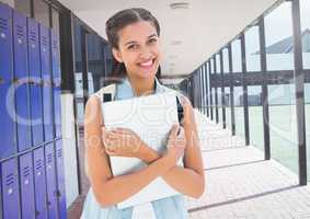 female student holding file in front of lockers