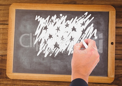 Hand drawing stars on blackboard