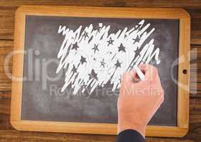 Hand drawing stars on blackboard