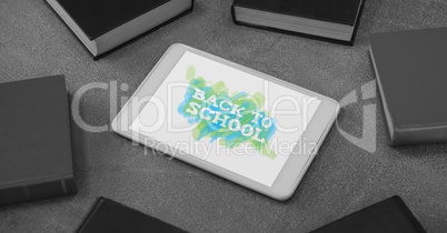 Tablet on a school table with back to school text on screen