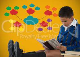 Boy reading in front of colorful clouds on yellow background
