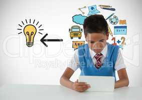 Schoolboy on tablet with education light bulb graphics