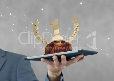 Person holding a tablet with a trophy