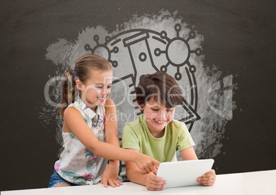Students at table using a tablet against grey blackboard with school and education graphic
