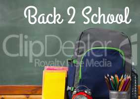 Schoolbag on Desk foreground with blackboard graphics of Back 2 School