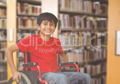 Disabled boy in wheelchair in school library