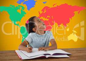 Schoolgirl writing at desk in front of colorful world map
