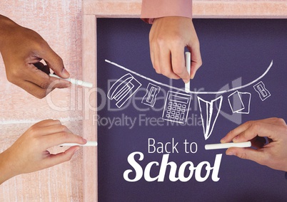 Hands drawing back to school text and stationery  on blackboard