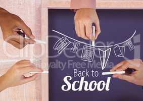 Hands drawing back to school text and stationery  on blackboard