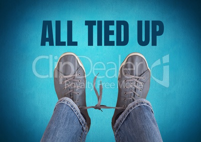 All tied up text  and grey shoes on feet with blue background