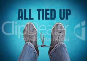 All tied up text  and grey shoes on feet with blue background