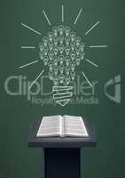 Book on speech table against green blackboard with bulb graphic