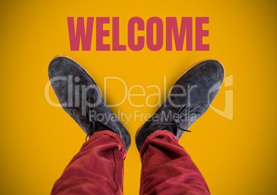 Welcome text and Grey shoes on feet with yellow background