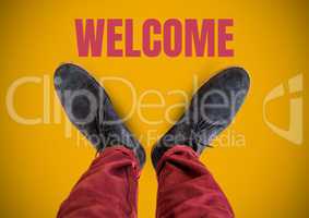 Welcome text and Grey shoes on feet with yellow background