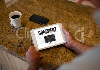 Comment text and chat graphic on tablet screen with hands