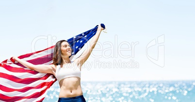 Woman holding a USA flag in the beach