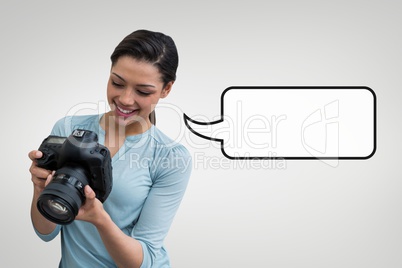 Happy photographer woman with speech bubble against grey background