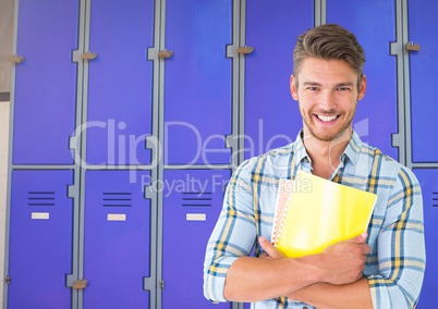 male student holding files in front of lockers