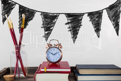 Books on the table against white blackboard with graphics