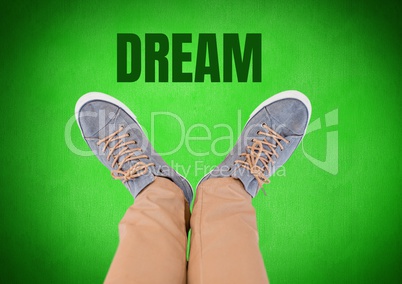 Dream text and grey shoes on feet with green background