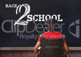 Back 2 school text on blackboard with disabled boy in wheelchair