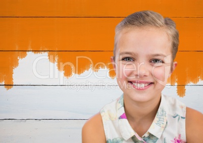 Girl smiling in front of painted orange wall
