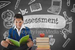 Happy student boy at table reading against grey blackboard with assessment text and education and sc