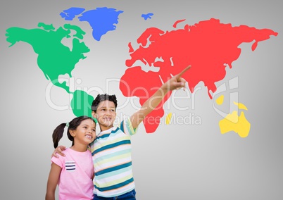 Kids pointing in front of colorful world map