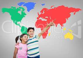 Kids pointing in front of colorful world map