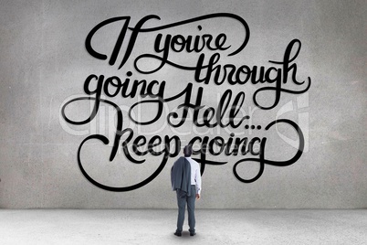 Business man standing in front of a motivational text