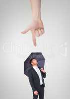 Hand pointing at business man with an umbrella against white background