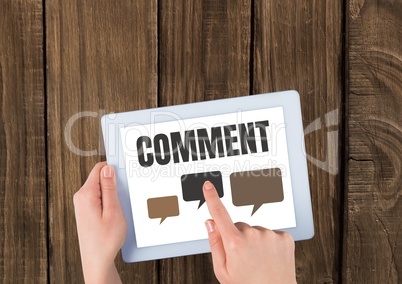 Comment text and chat graphic on tablet screen with hands