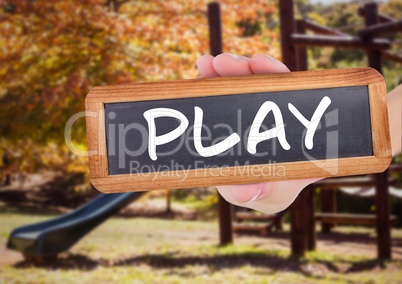 play text on blackboard in front of playground