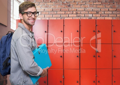 male student holding folder in front of lockers